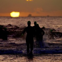 A beautiful sunrise greets the athletes as they head into the water for the 1.9km swim (Chris Hitchcock for IRONMAN)