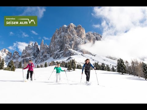Snowshoe hiking in the snow-blanketed Dolomites